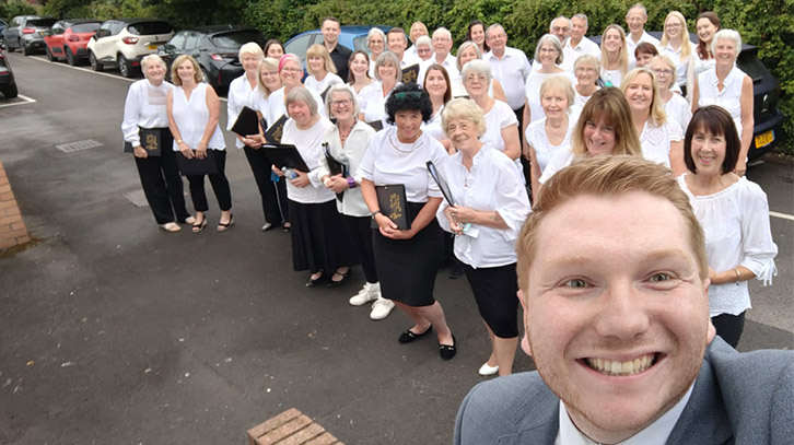 members of the llysfaen singers and their md tom lazell posing outdoors