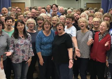 choir members singing together, posing for camera before lockdown