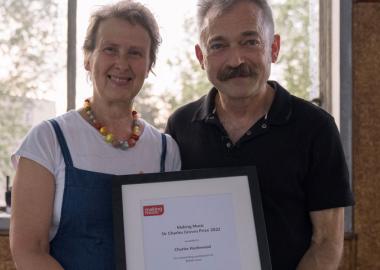 Making Music chief executive and Charles Hazlewood smiling, together holding framed Sir Charles Groves prize